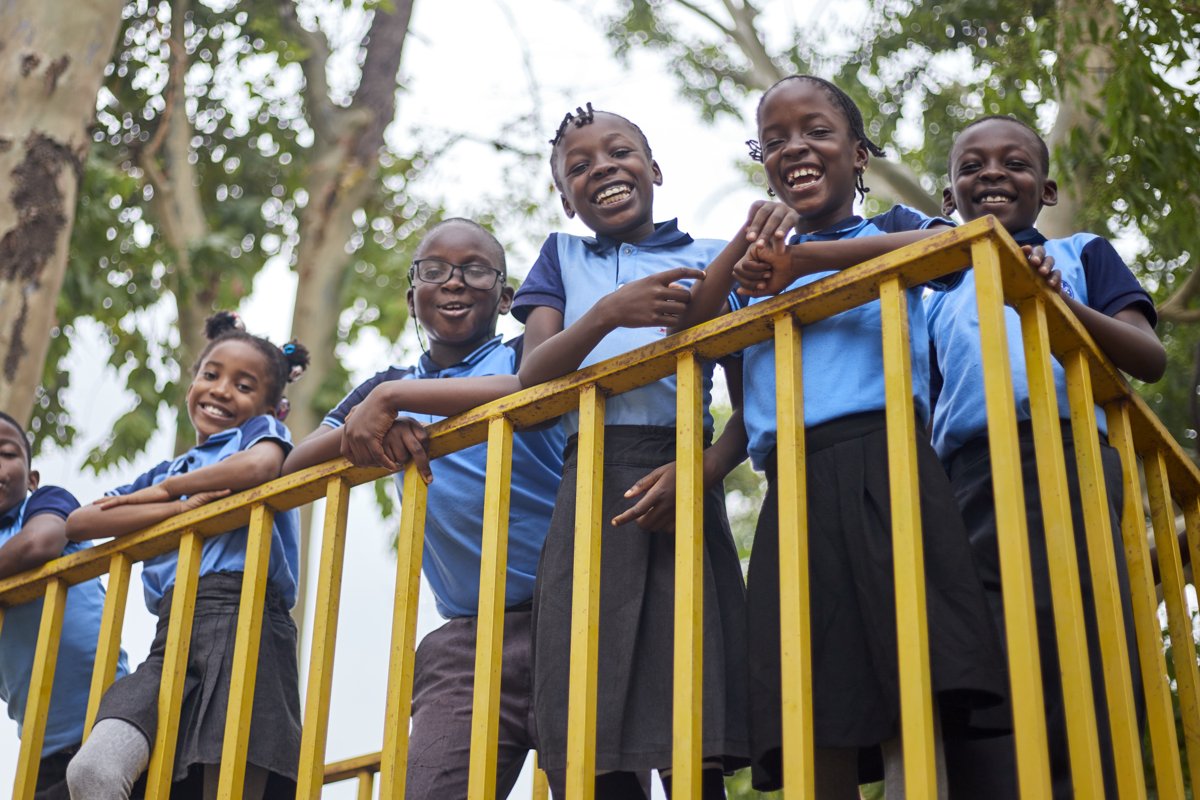 Bomas Academy students embracing joyfully on the playground