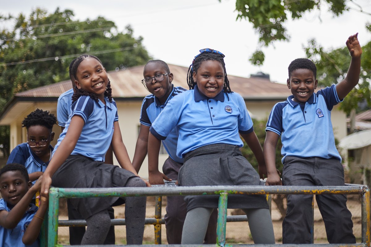 Bomas Academy students sitting together on the playground